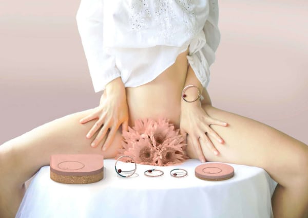 Figure of woman sitting on table surrounded by pink menstrual products (from Aneo by Ines Duplessis, MA Industrial Design)