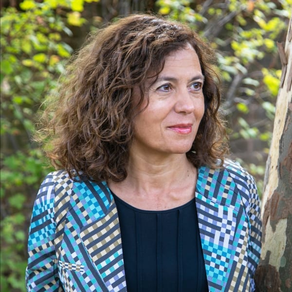 Headshot of Vali stood in front of a tree