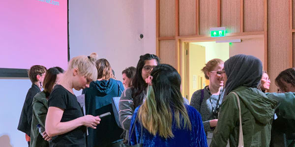 A group of attendees chatting at a CCI workshop event