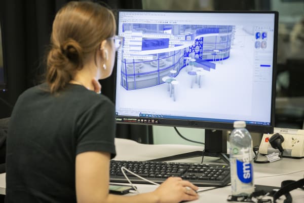 A room with people working at computers