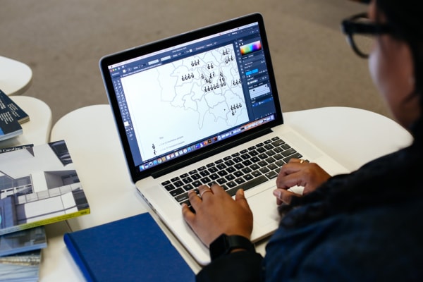 PhD student working on a laptop