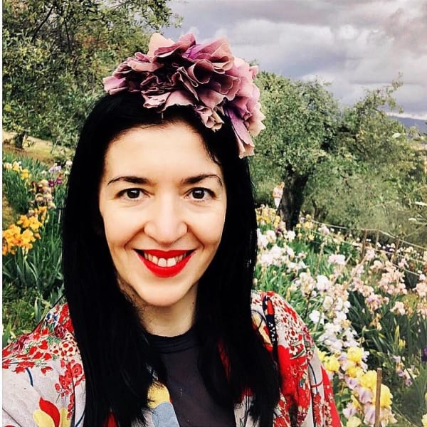 Profile picture of Elisa smiling on a hillside.