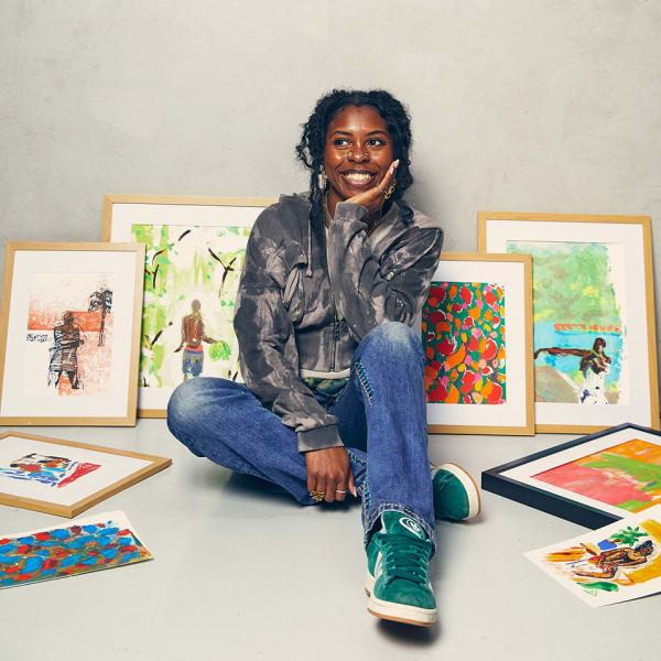 Davinia Clarke sits on the floor surrounded by her framed prints.
