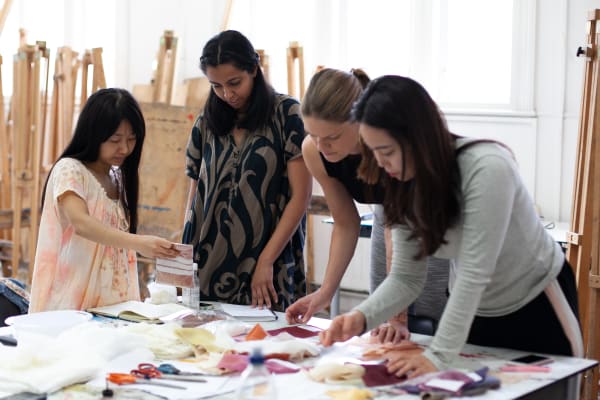 Students looking at fabric swatches 