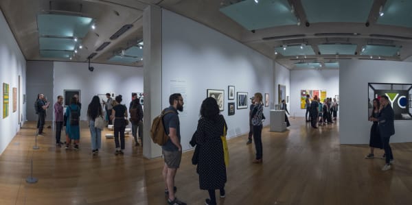People looking at artworks in an exhibition
