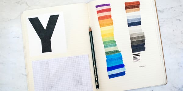Sketchbook with rainbow coloured lines.