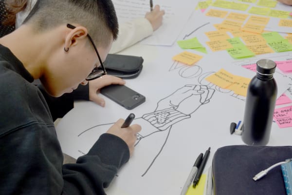 Student working on magazine cover design.