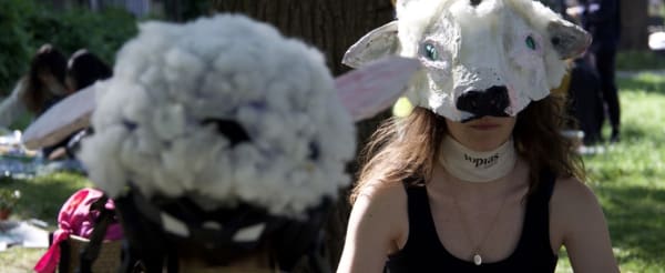 Photo of people wearing animal masks in an outdoor setting.