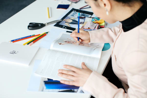 Student writing on a book