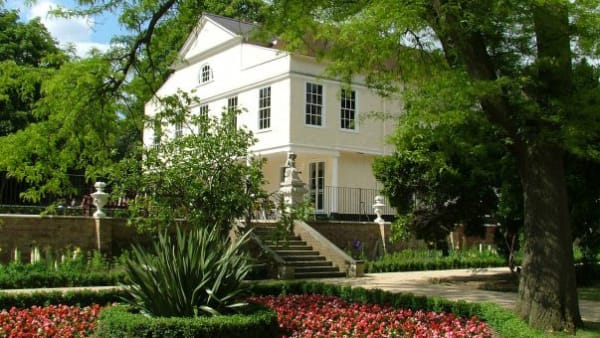A white building surrounded by trees