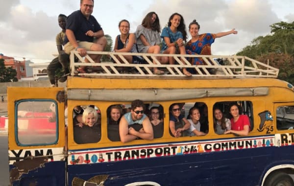 Students and staff pose for a photograph on a bus in Senegal.