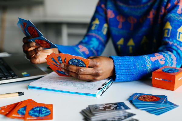 Student looking through a game of cards.