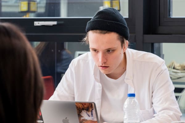 A student working at a laptop