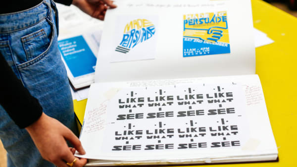 Open sketchbook showing typography that reads 'Made to Persuade' and 'I like what I see' in different formats. 