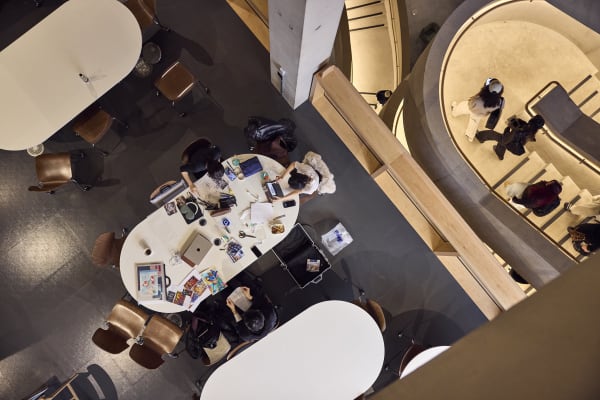Students working at desk next to East Bank staircase