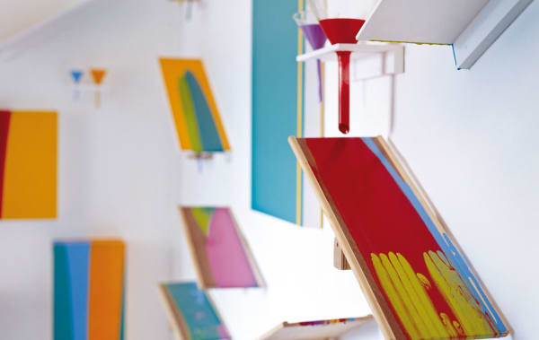 Installation of multicoloured, angled ledges on a white wall