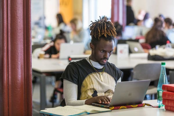 Student at desk using a laptop