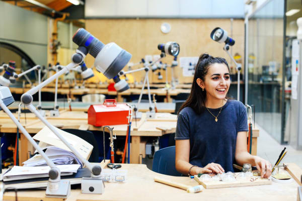 Girl in workshop with tools and a big lamp 