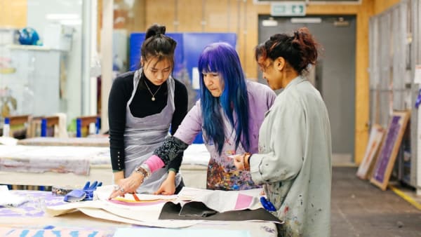 A tutor working with two students