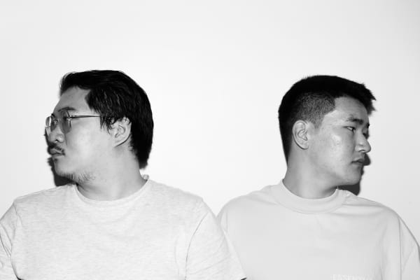 Black and white photo of two figures.