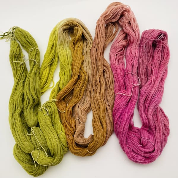 Vibrant green, orange and pink dyed yarns