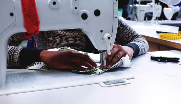 Making for Change participant using a sewing machine