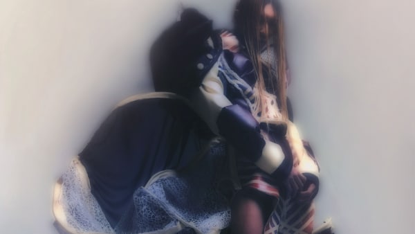 Figure wearing complex garments creating large silhouette