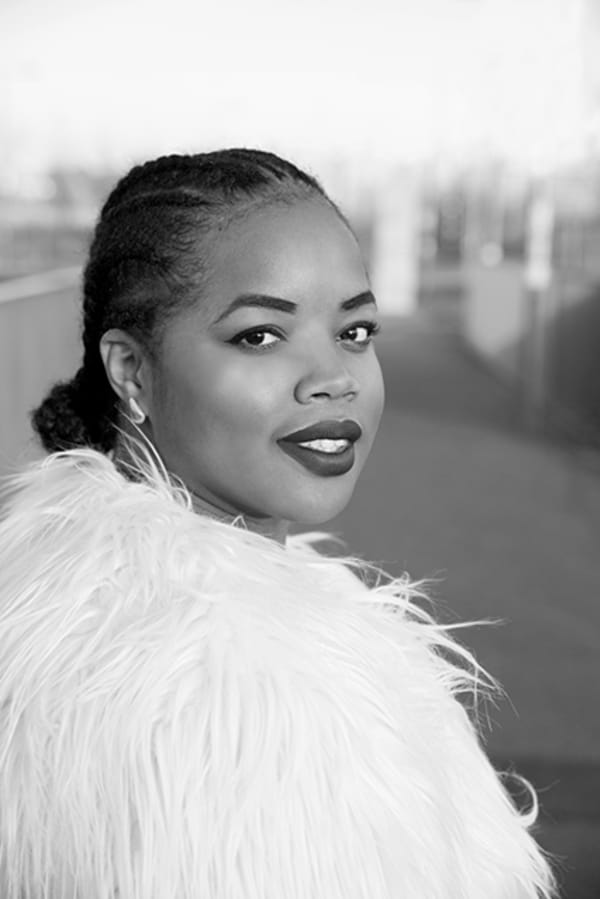 Black and white portrait of Florence Adepoju looking back to the camera.