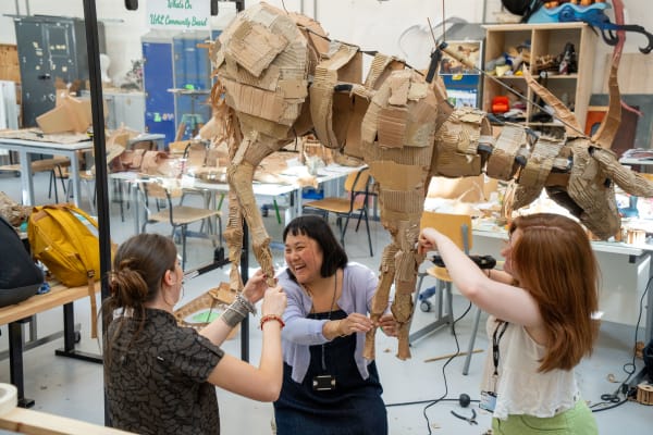 3 women building the Herds sculpture