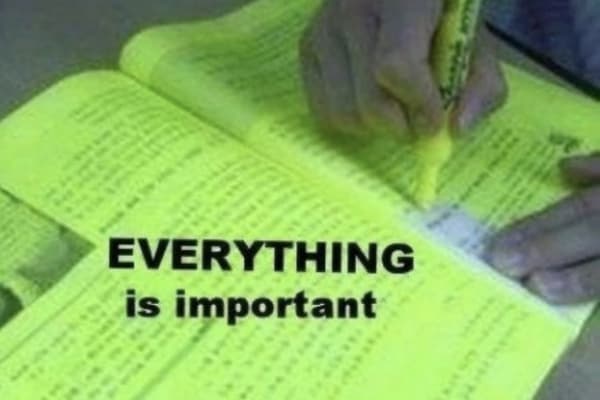 A hand uses a yellow highlighter on a fully highlighted book page. The text, 