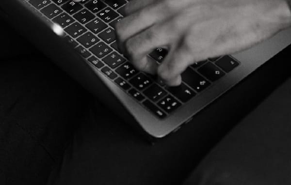 Close up of hands typing on a laptop