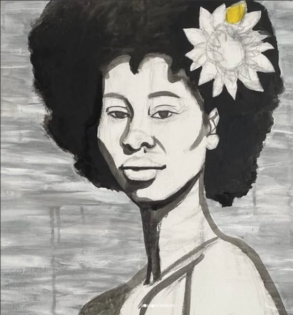 Black and white image of a woman with a flower in her hair