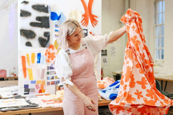 student look at some fabric
