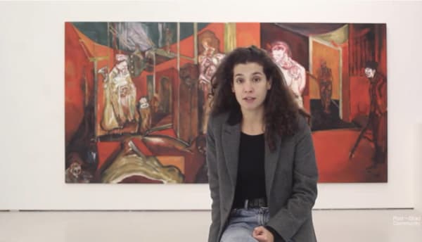 woman sat in front of her large painting