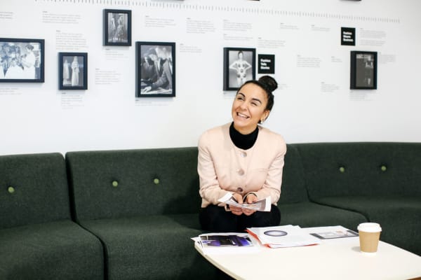 Student seated on sofa in setting at London College of Fashion.