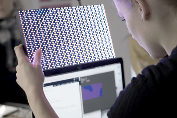 Image of a student working with an electronic device 