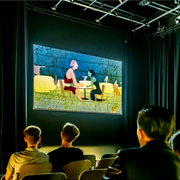 poeple sitting infront of a projection