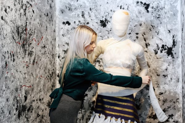 Woman dressing a mannequin, BA Fashion Visual Merchandising and Branding, Tabby Ullah in the studio, Copyright holder: Alys Tomlinson
