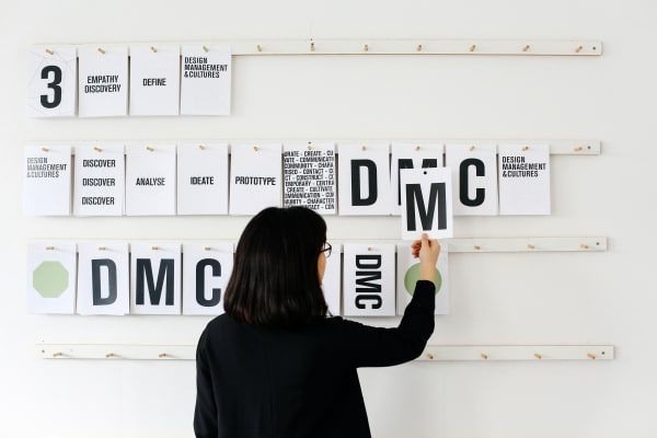 Student adding notes to a board
