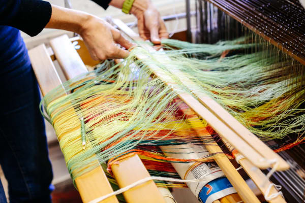 Technician using the weave machine.