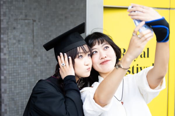 Two students taking a selfie at Graduation
