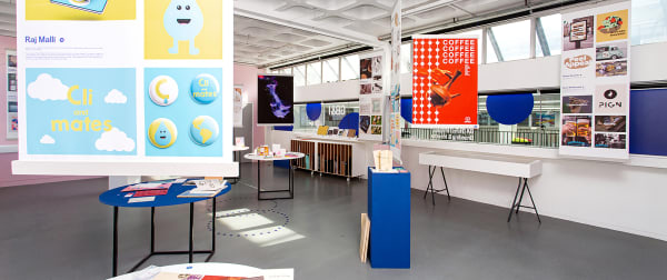Exhibition shot of graphic branding and identity work inlcuding posters and colourful displays.