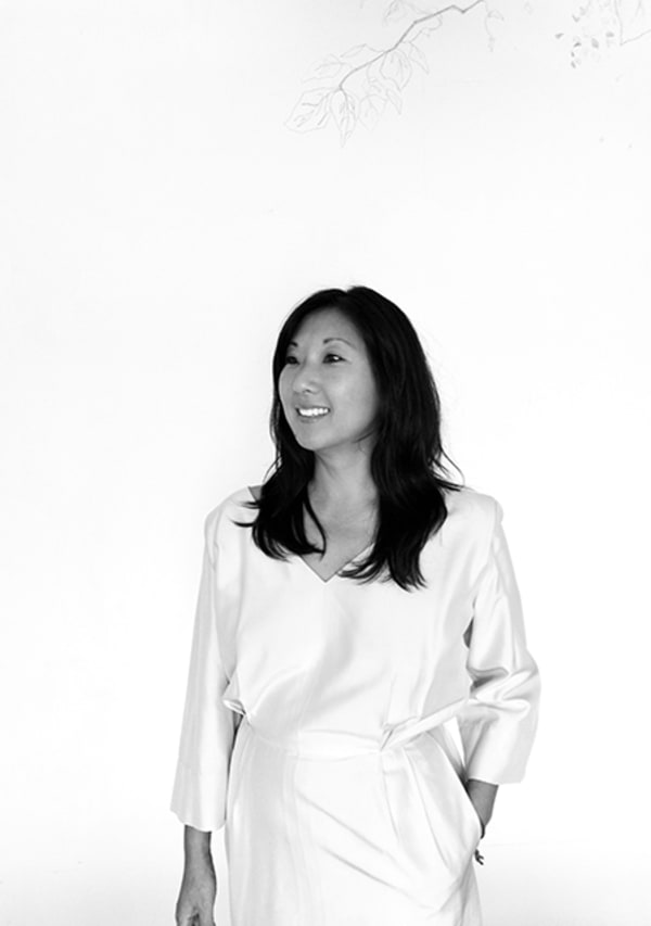 A black and white portrait of a woman with long black hair.