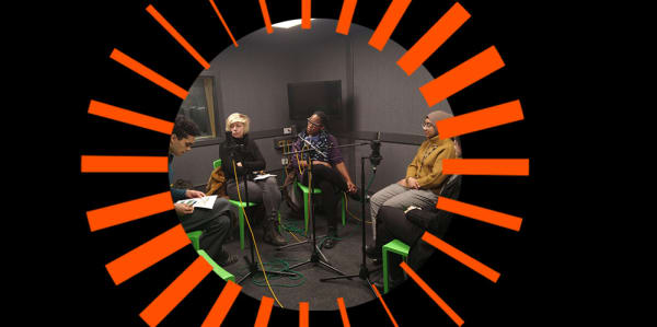 5 people having a discussion in a recording studio