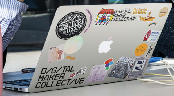 a laptop with stickers on it 