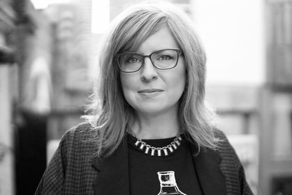 Black and white portrait of Cyndi Rhoades looking straight at the camera