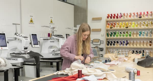 A student working with material at a table 