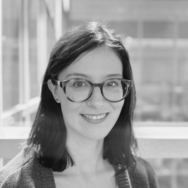 Myriam Cherif, a woman with dark brown hair wearing glasses smiling at the camera