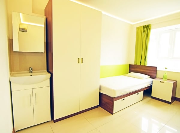Cedars Hall Standard room (shared bathroom) including single bed, very large wardrobe, sink basin with mirror and desk