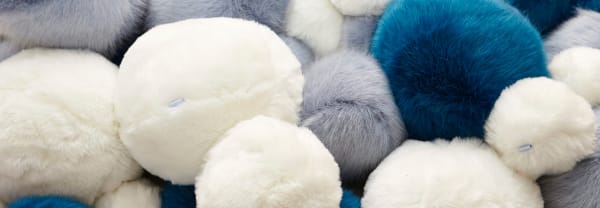 Close-up shot of blue, white and grey fluffy balls
